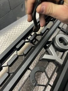 photo of Cutting TRD Pro Grill With Dites to modify for front facing camera mount bracket on 2020, 2021, 2022, 2023 Toyota Tacoma TRD Pro Style Heritage Grill