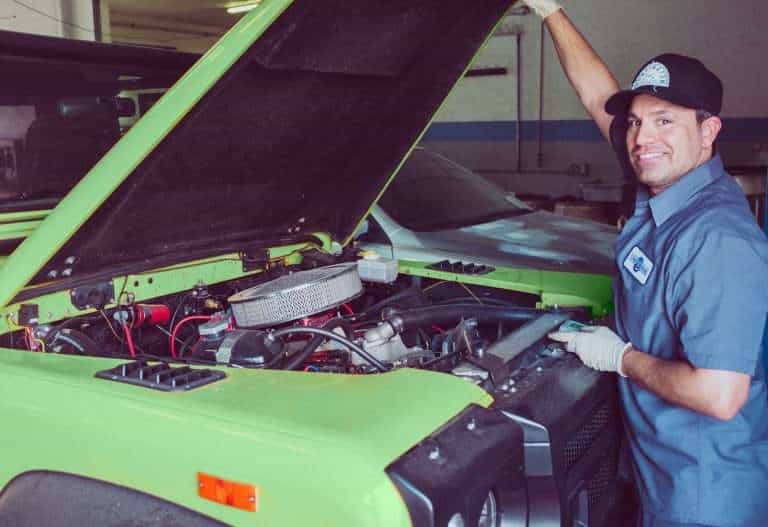 image of mechanic working on Jeep