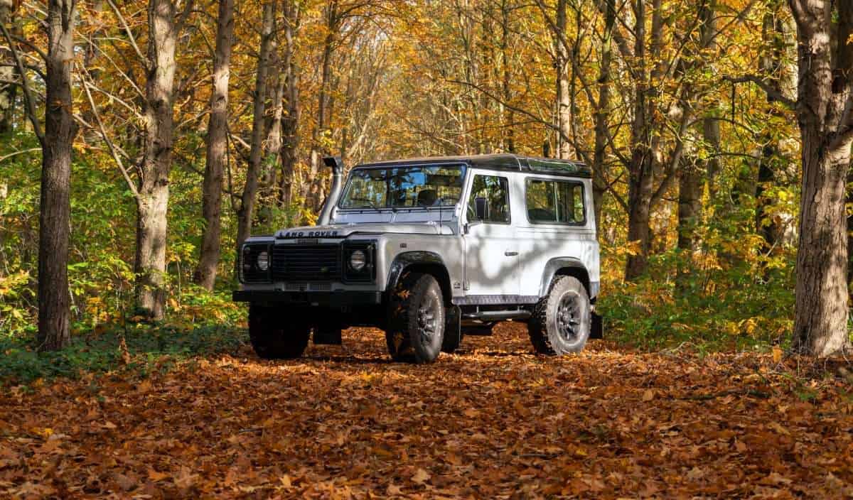 land rover offroad sitting in the woods