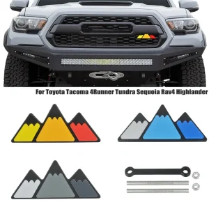 Mountain Grille badge with tacoma in back ground three tri color options shown